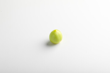 green tomato on white background.