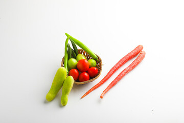 Raw vegetable in wooden bowl on white background.