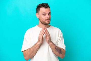 Young Brazilian man isolated on blue background scheming something