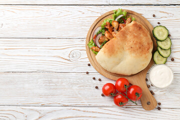 Concept of tasty food with pita with chicken, space for text