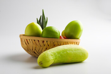 Raw vegetable in wooden bowl on white background.