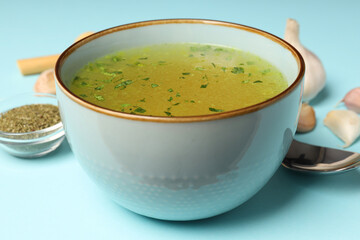 Concept of tasty food with broth on blue background