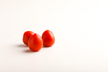 Fresh red tomato on white background.