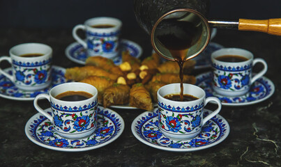 Obraz na płótnie Canvas Turkish baklava and coffee on the table. Selective focus.