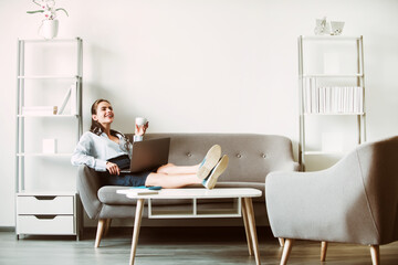 Break time concept. Joyful young web developer drinking coffee while taking break from work in office.