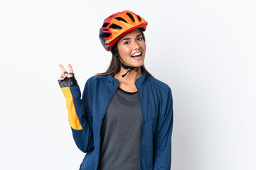 Young cyclist brazilian girl isolated on white  background smiling and showing victory sign