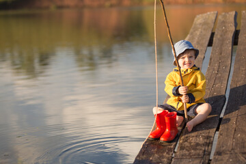 Little Boy Catching a Fish from wooden dock