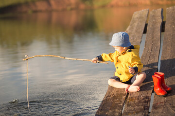 Little Boy Catching a Fish from wooden dock