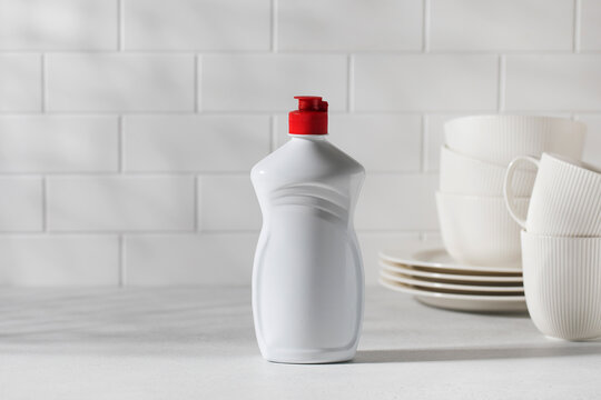 A mockup of a white plastic bottle with liquid dishwashing detergent. Banner. Copy space.