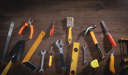 Work tools on the wooden background.