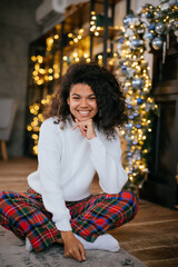 Fototapeta premium Beautiful young african american woman on the floor