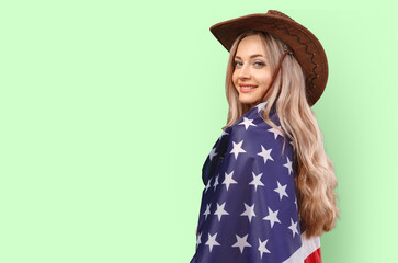 Portrait of a young woman holding USA flag isolated on color background