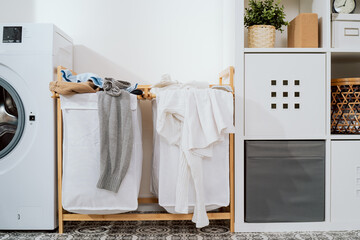 The interior of the home laundry room, next to the washing machine stand baskets for dirty clothes...