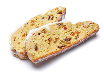 Slices of Traditional Christmas stollen cake with marzipan and dried fruit isolated on white background