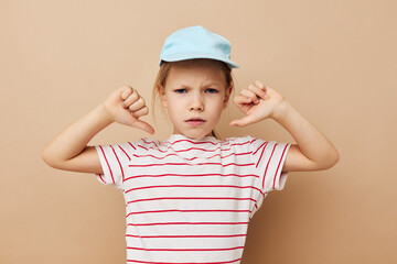 little girl in blue caps striped t-shirt emotions Lifestyle unaltered