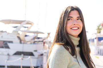 Young Brazilian woman at outdoors with happy expression