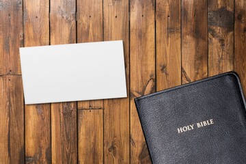 Concept of message on wooden background with closed Bible. God Jesus Christ