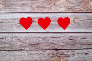 red hearts on wooden background, copy space, top view