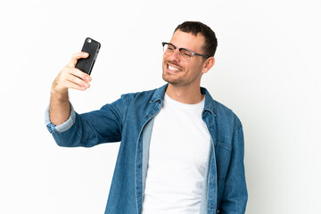 Brazilian man over isolated white background making a selfie