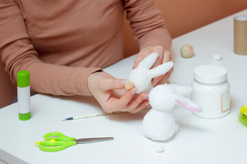 Obraz na płótnie Canvas Handmade Easter decoration cute little rabbit. Making cute bunny toy DIY for kids. Spring home activities