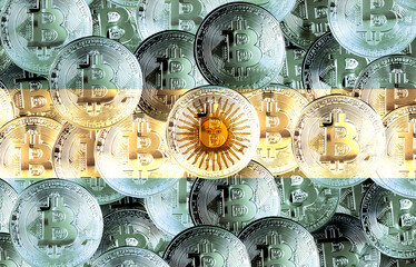 Holds a physical version of Bitcoin and the Argentine flag. Conceptual image of cryptocurrencies...