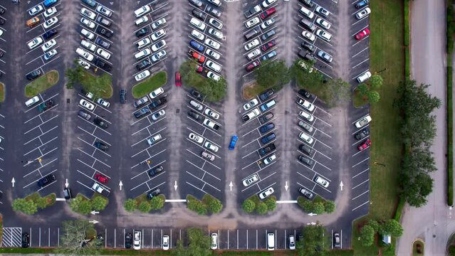 Drone time lapse straight down over a Publix parking lot in Palm City Florida, Cars and trucks parking in busy parking lot in south Florida,