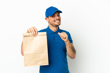 Brazilian taking a bag of takeaway food isolated on white background proud and self-satisfied