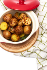 Baked potato in a clay pot isolated on white background