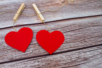 Top view of valentines hearts on wooden  background. Symbol of love and Saint Valentine's Day concept. Two red hearts. Copy space.