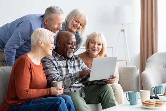 Happy elderly people spending time together at home