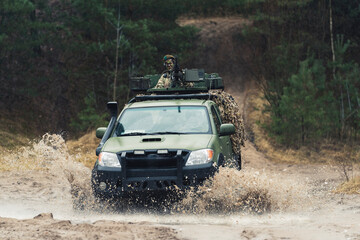 Countering challenging terrain obstacles on a armed patrol army truck. High quality photo