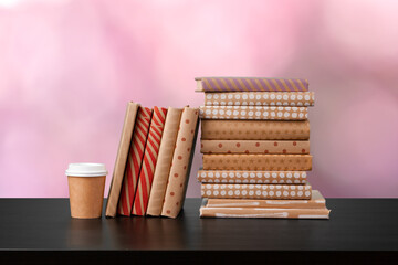 Stack of books on wooden table against blurred background