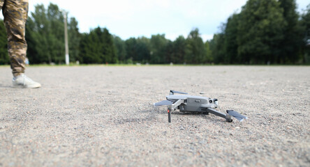 Small digital drone stands on ground closeup