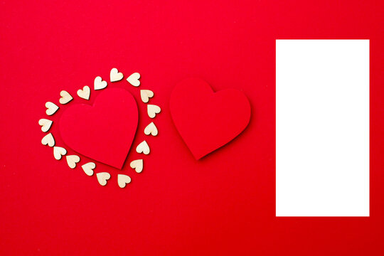 Two red hearts on red background. Mockup. Valentine's day. Copy space. Vertical photo.