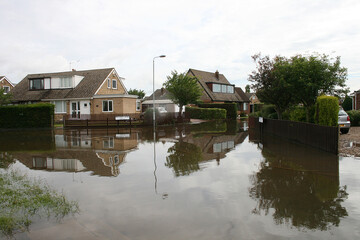 Fototapeta na wymiar flood disaster zone, flooded houses and streets, flash flooding extreme weather 