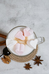Coffee foam is poured into a mug with milk. Making latte