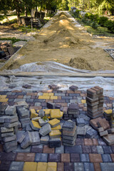 Laying paving slabs of park alley. Carrying out preparatory work. Selective focus.