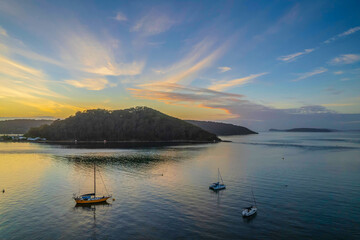 Obraz na płótnie Canvas Aerial sunrise waterscape with boats