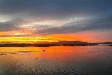 Sunrise waterscape with a mix of low, medium and high clouds