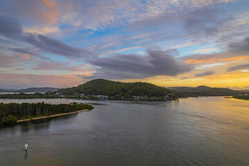 Sunrise waterscape with a mix of low, medium and high clouds