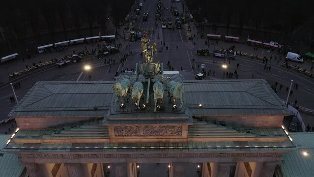 Close up of quadriga sculpture on top of Brandenburger Tor. Aerial descending footage of chariot drawn by four horses. Berlin, Germany