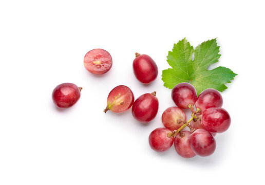 Flat lay (top view) of red grape with leaves on white background.