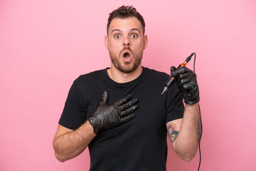 Tattoo artist brazilian man isolated on pink background surprised and shocked while looking right