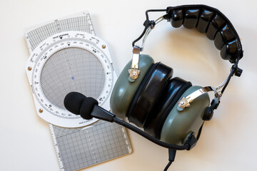 Navigation computer and flight headset as concept for flight school or aircrew licensing.