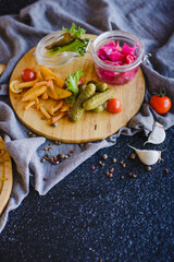 Wooden tray with sliced salami, basturma, cheese and other snacks