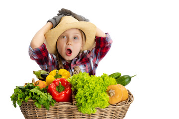 Shocked cute little girl, emotive kid in image of farmer, gardener with large basket of vegetables...