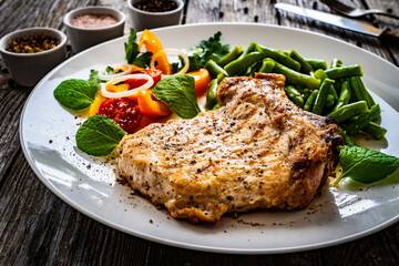 Grilled steak with boiled green bean on wooden table 