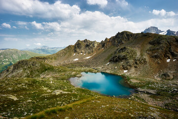 Fototapeta na wymiar Alpine turquoise lake of Sofia, surrounded by rocks. Karachay-Cherkessia, Arkhyz. Russia