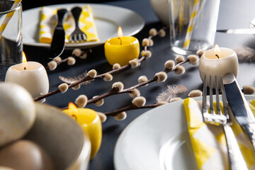 easter, holidays, tradition and object concept - close up of dinner party table serving over black background