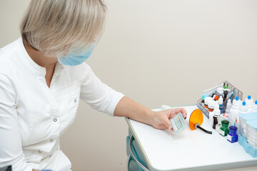 dentist a young white woman is sitting at a table with medicines and dental instruments
